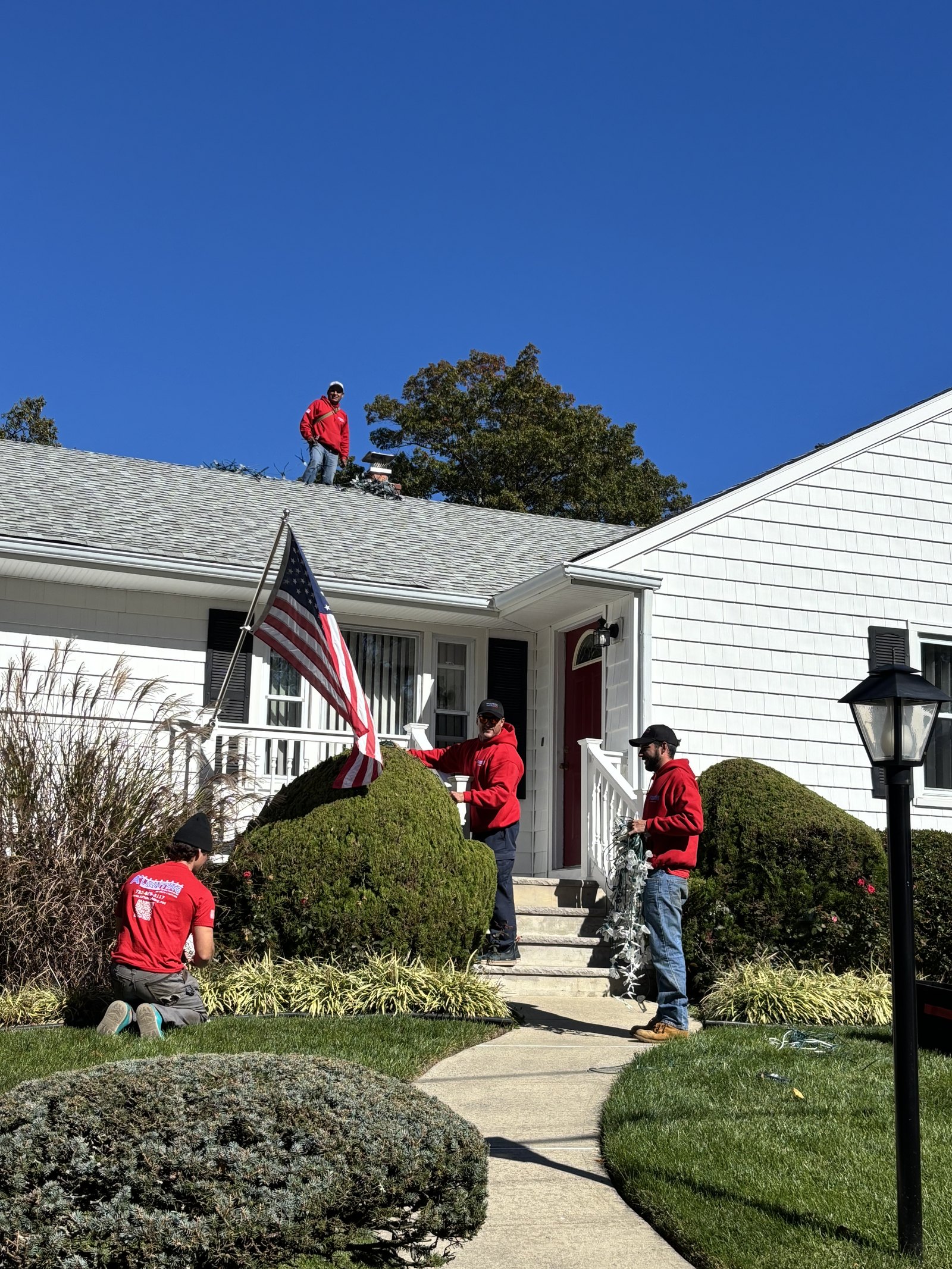 A+ Lighting crew installing Christmas lighting at a Monmouth County home