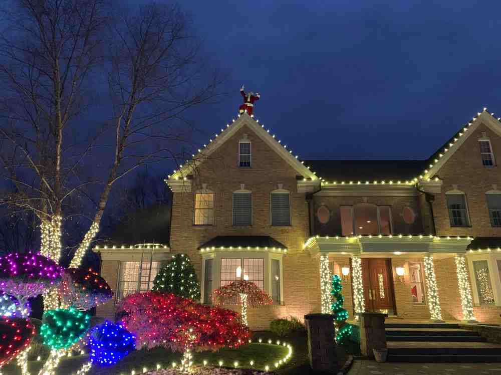 Custom Christmas lighting display with RGB color and warm white on a New Jersey home
