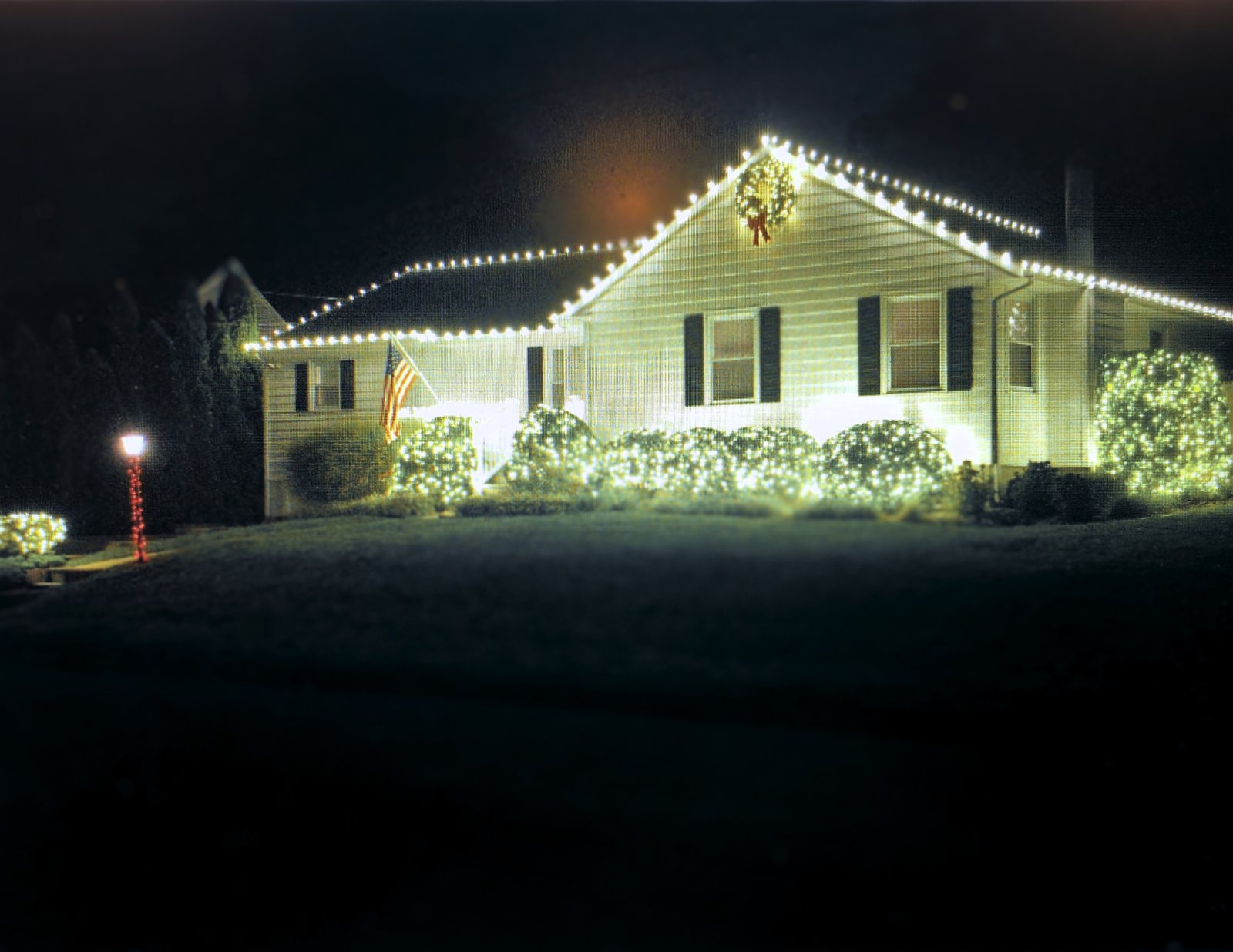 Actual Christmas lighting installed on the same New Jersey home at night